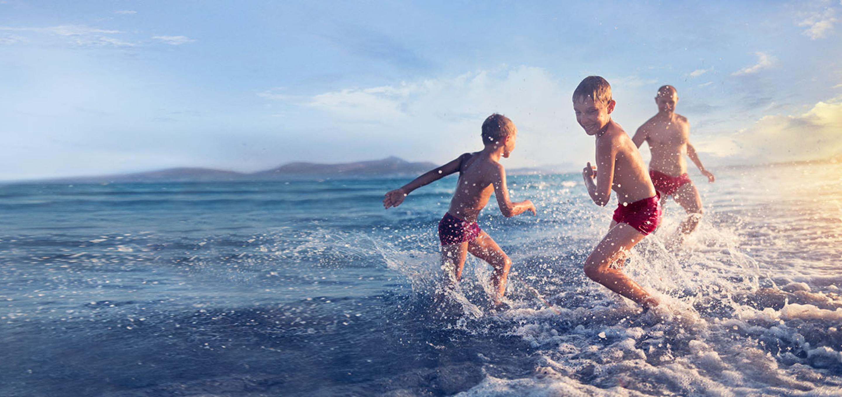 An image of children playing in the sea