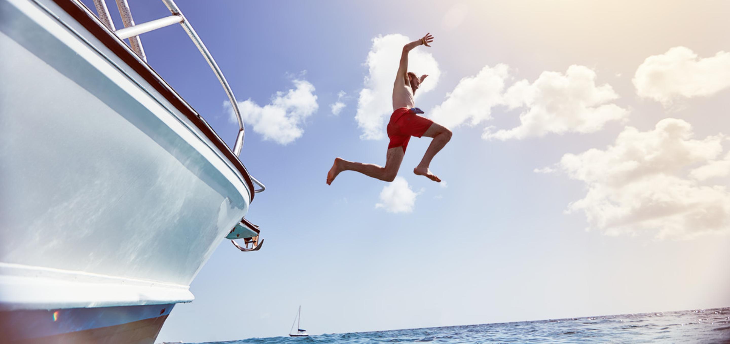 An image of a man jumping off a boat